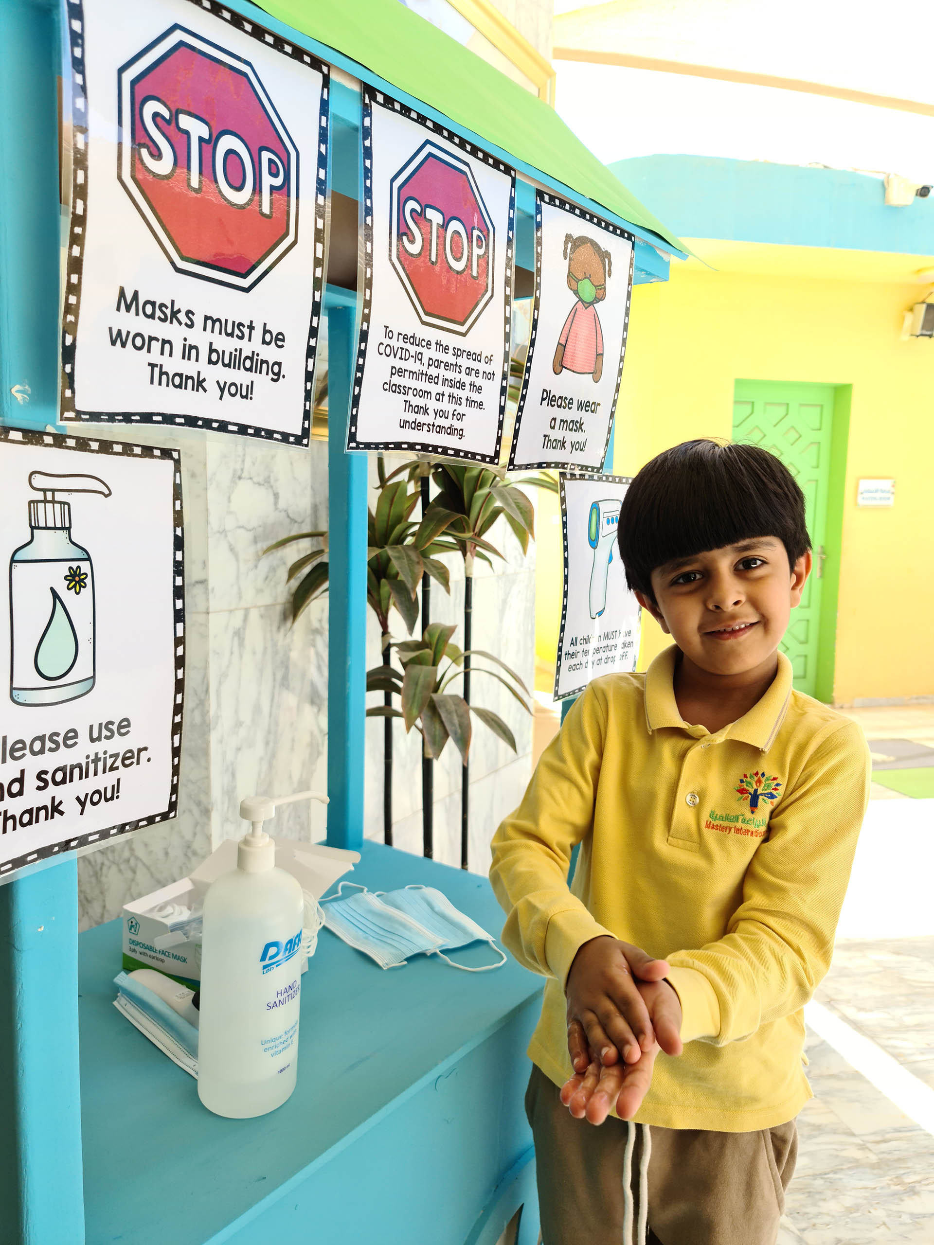 Kids using sanitizer in school 